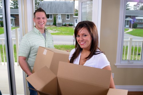 Professional movers carrying furniture in a flat move