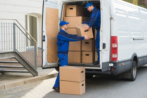 Removal van and moving boxes in a West Hampstead street