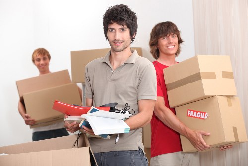 Professional movers navigating stairs in a West Hampstead home