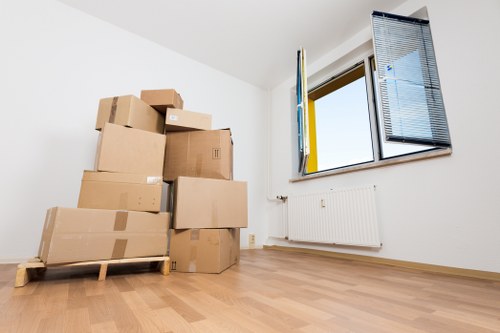 Professional movers carrying furniture from a flat in West Hampstead
