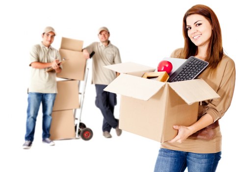 Packers loading boxes and office equipment for a business move