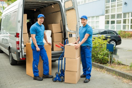 Loading furniture into a removals van on a West Hampstead street