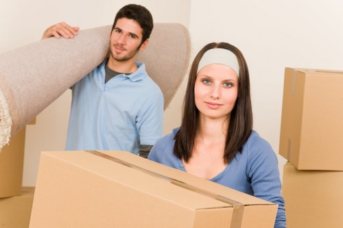 Moving team handling boxes near West Hampstead flats and apartments